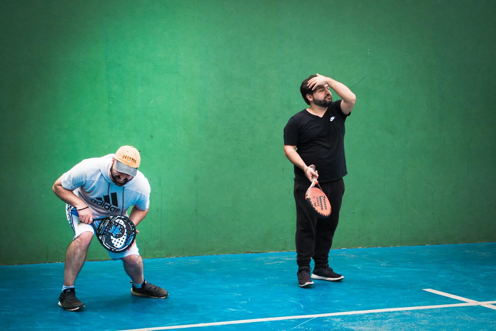 a man holding a tennis racquet on top of a tennis court